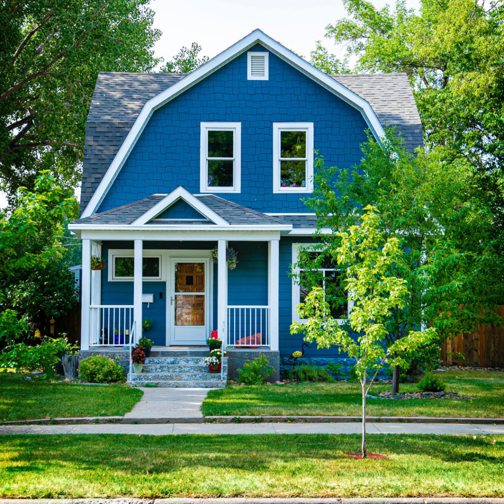 Blue and white house with green lawan