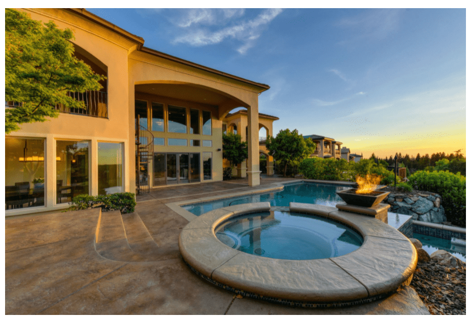 Outdoor living area with a fire pit and pool that's perfect for a new real estate developer